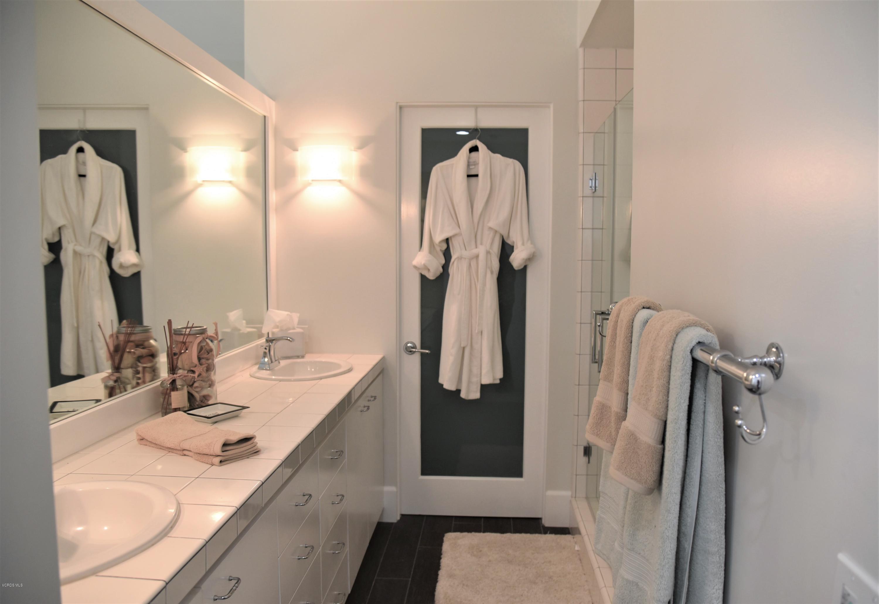 4885 Sandyland Road, Unit 2 Carpinteria, CA 93013 - Photo 20 of 39 a bathroom with a sink vanity and a mirror