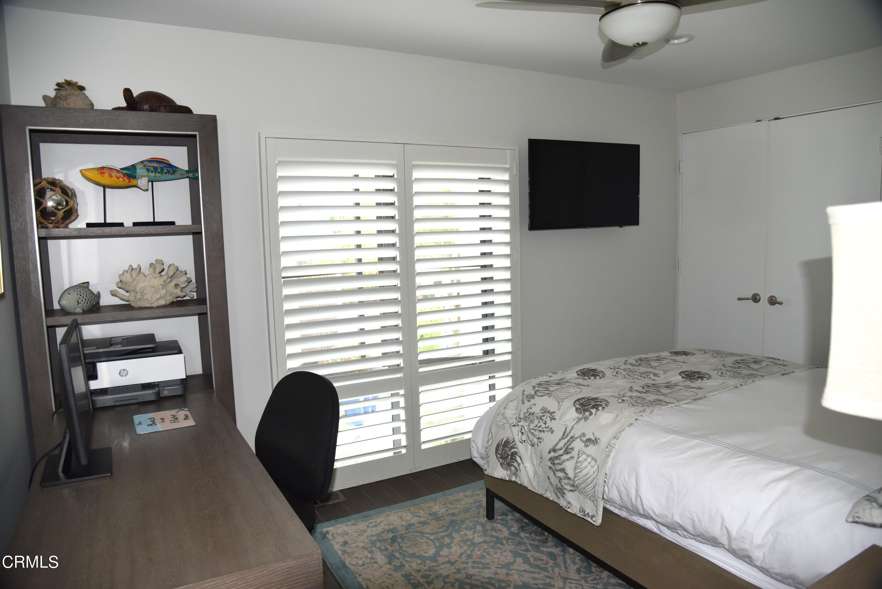 4885 Sandyland Road, Unit 2 Carpinteria, CA 93013 - Photo 27 of 39 a bedroom with a bed and a flat screen tv