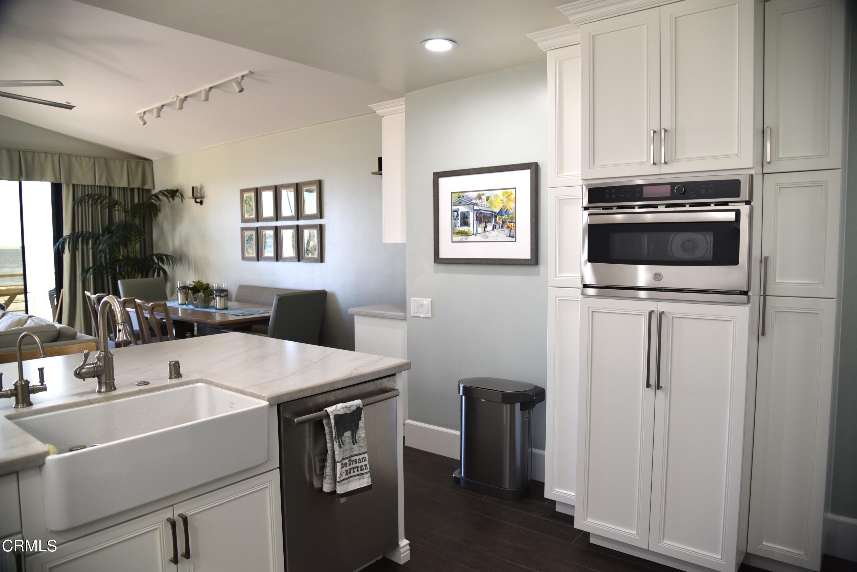 4885 Sandyland Road, Unit 2 Carpinteria, CA 93013 - Photo 9 of 39 a kitchen that has a sink and a stove in it