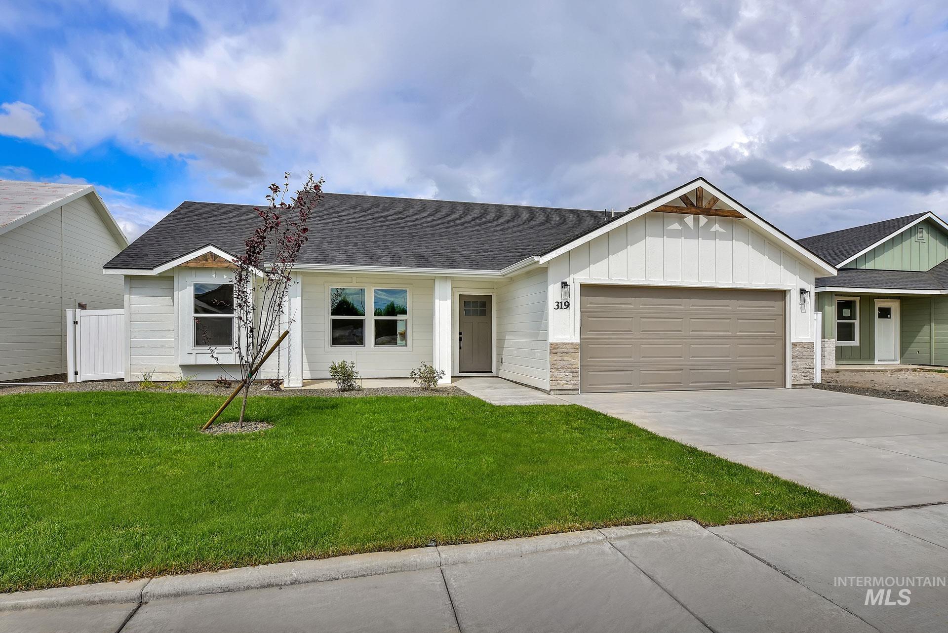 1160 Velvet Loop Wilder, ID 83676 - Photo 1 of 29 View of front facade with a shingled roof, board and batten siding, a front lawn, and a garage