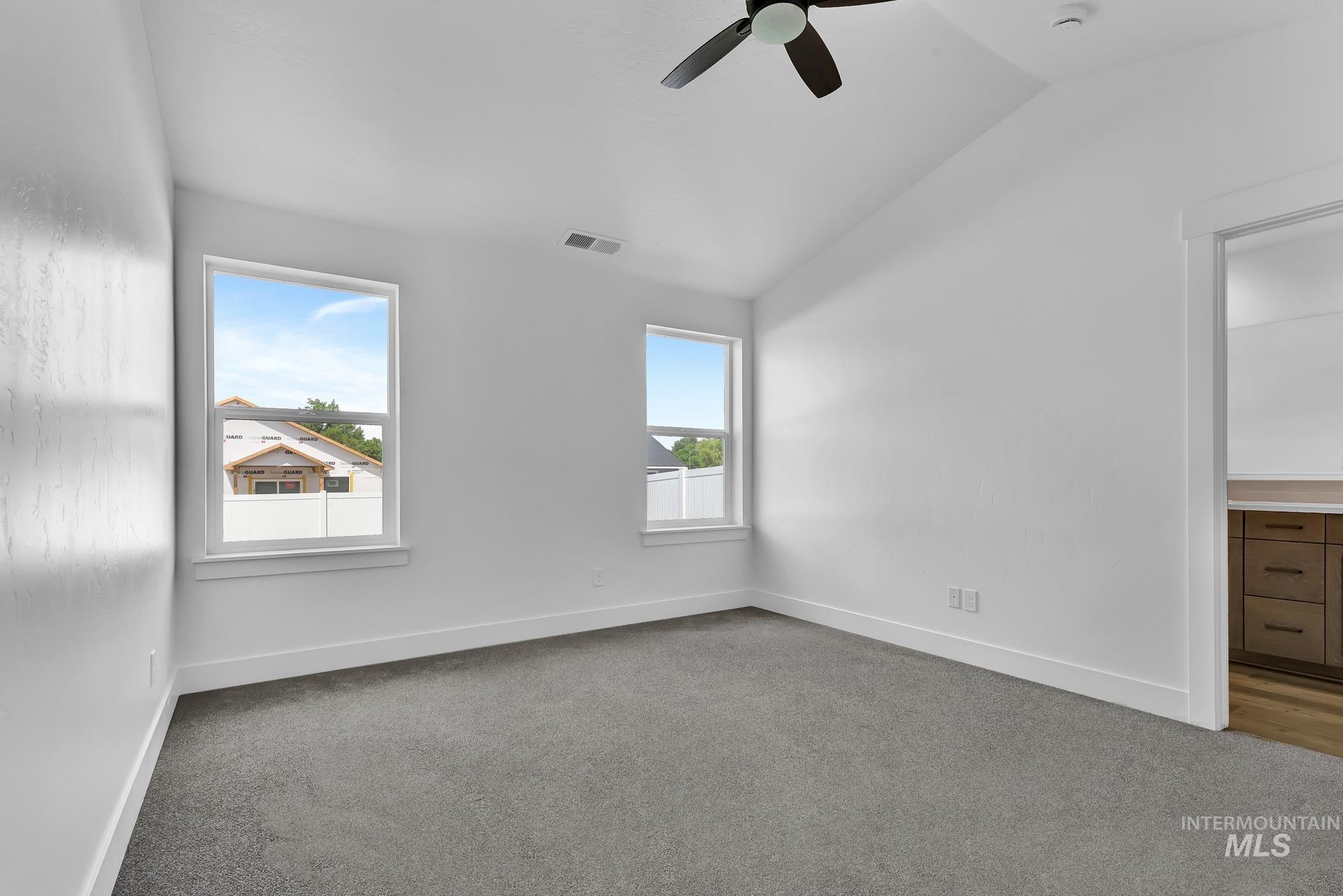 1160 Velvet Loop Wilder, ID 83676 - Photo 11 of 29 Spare room with vaulted ceiling, carpet flooring, and ceiling fan