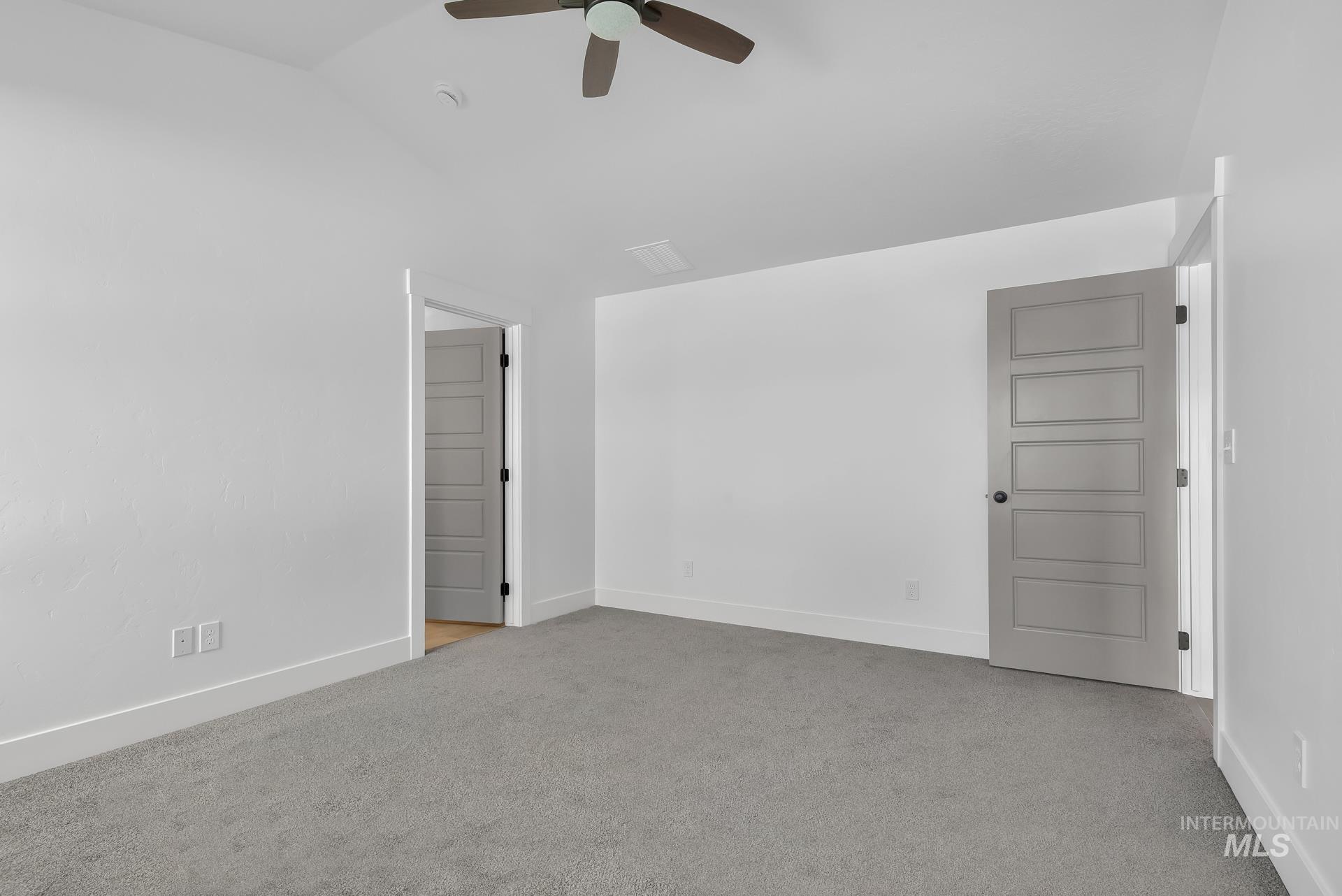1160 Velvet Loop Wilder, ID 83676 - Photo 12 of 29 Empty room featuring light carpet, a ceiling fan, and lofted ceiling