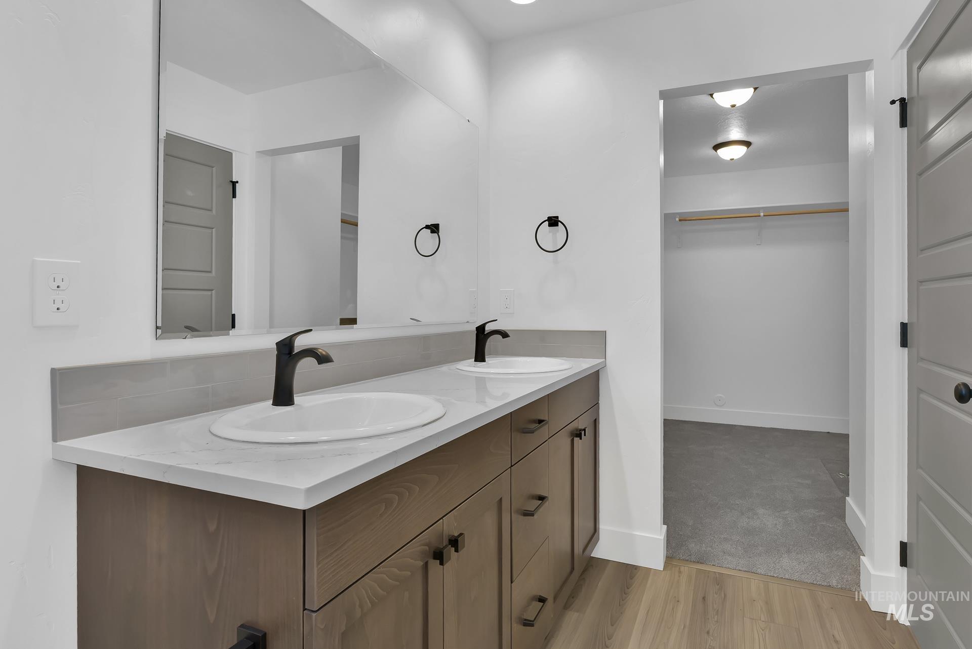 1160 Velvet Loop Wilder, ID 83676 - Photo 15 of 29 Full bathroom featuring double vanity, a spacious closet, and light wood-type flooring