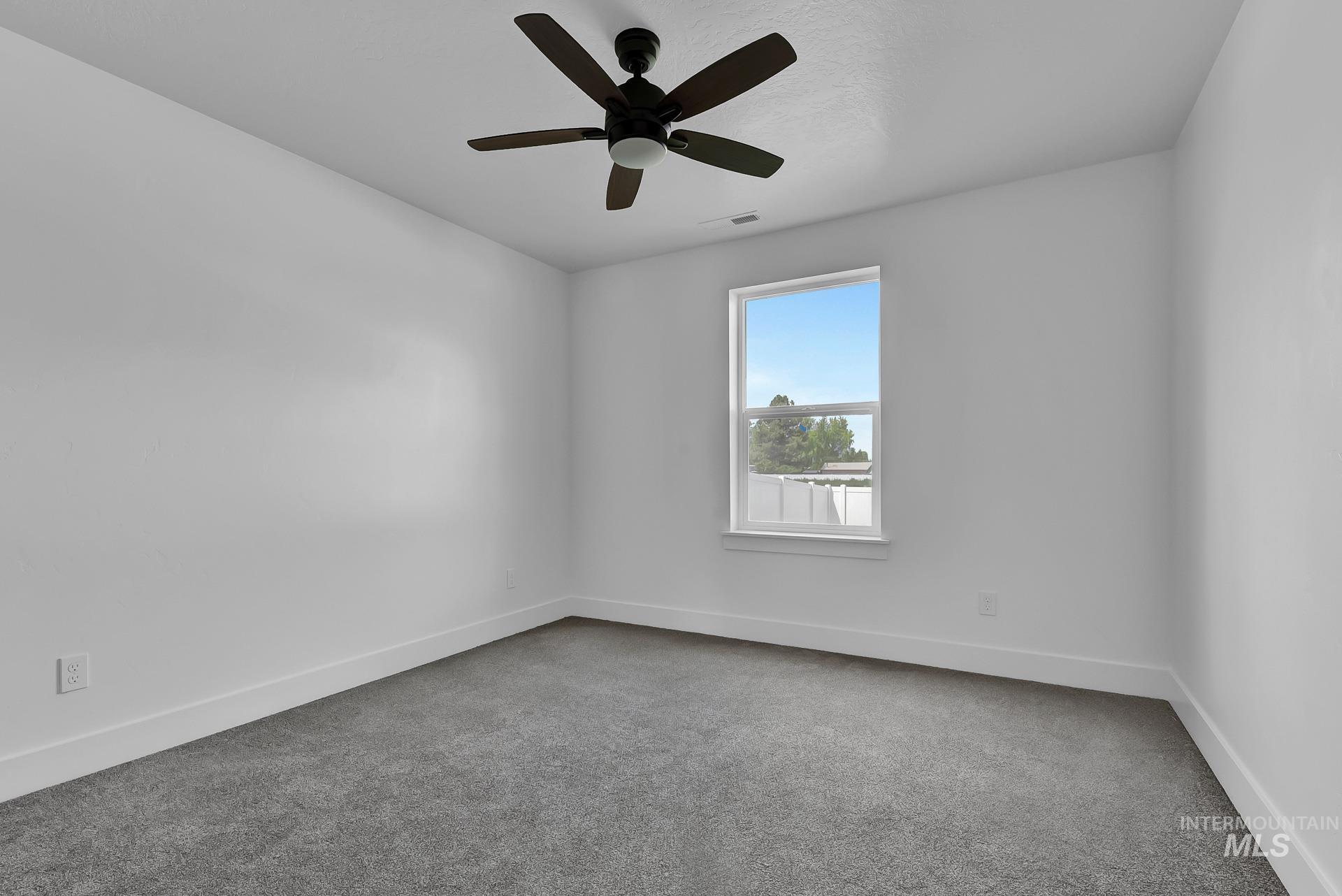 1160 Velvet Loop Wilder, ID 83676 - Photo 19 of 29 Empty room featuring light carpet and a ceiling fan