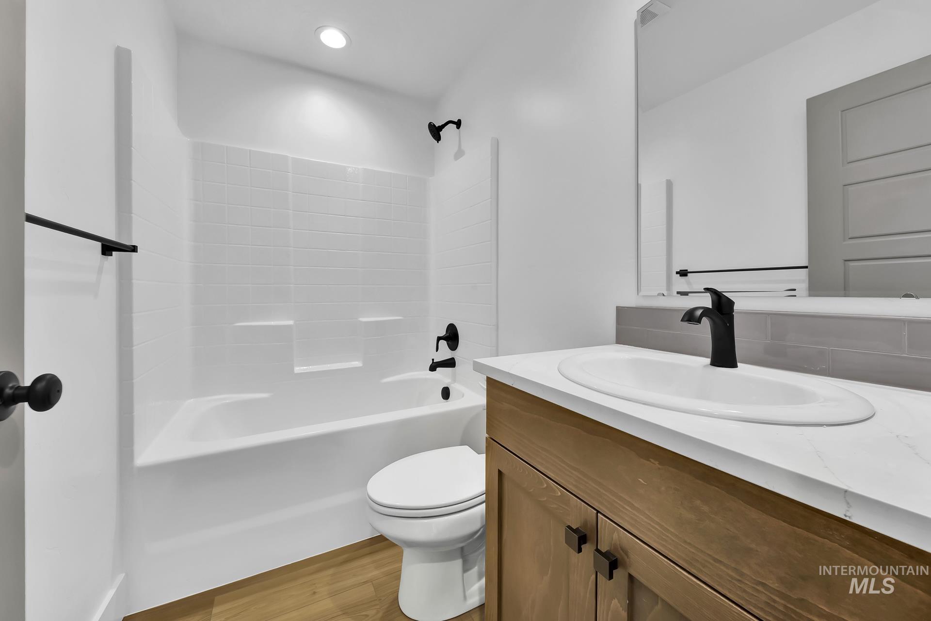 1160 Velvet Loop Wilder, ID 83676 - Photo 21 of 29 Bathroom with vanity, washtub / shower combination, and light wood finished floors