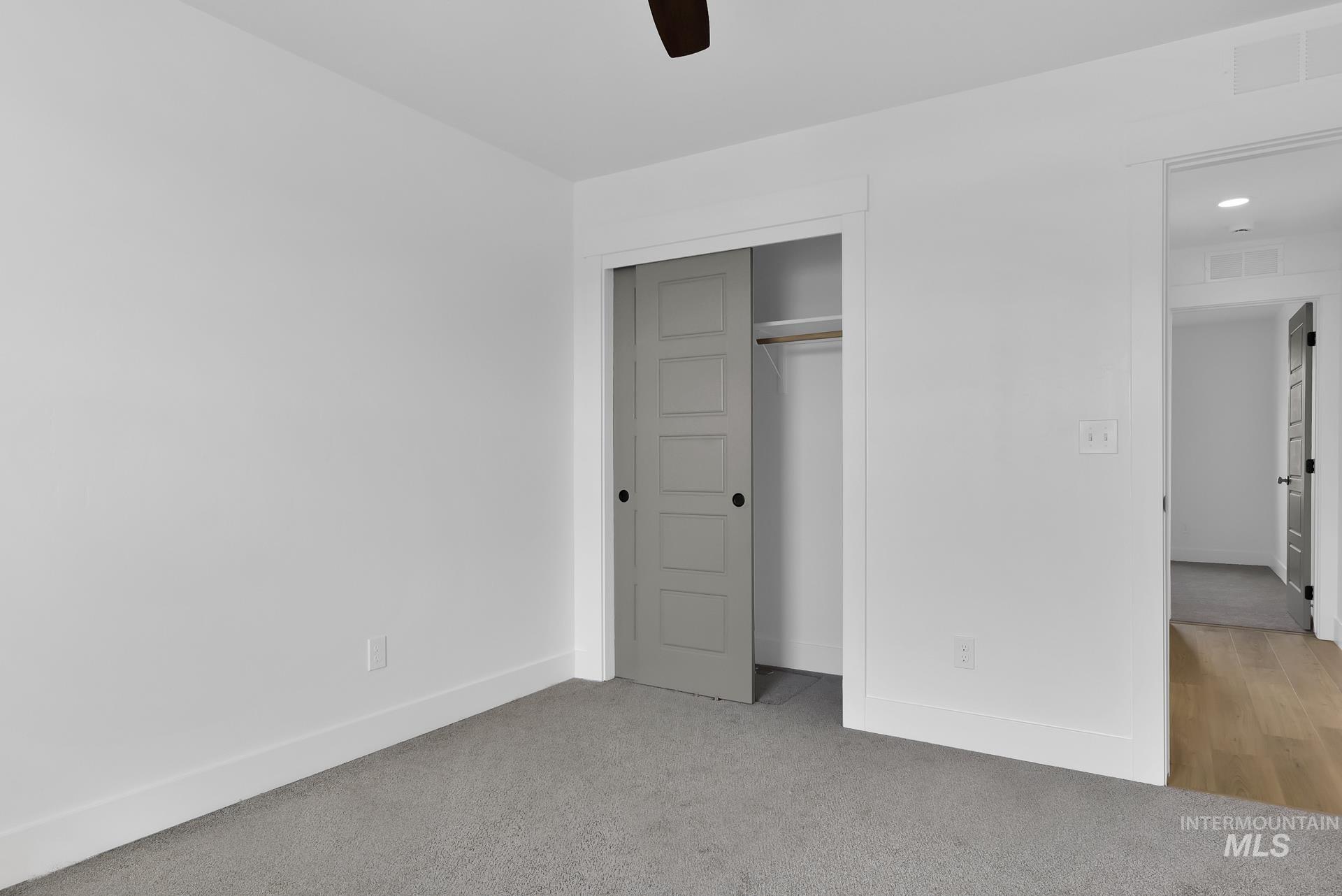 1160 Velvet Loop Wilder, ID 83676 - Photo 23 of 29 Unfurnished bedroom featuring a closet, light colored carpet, and a ceiling fan