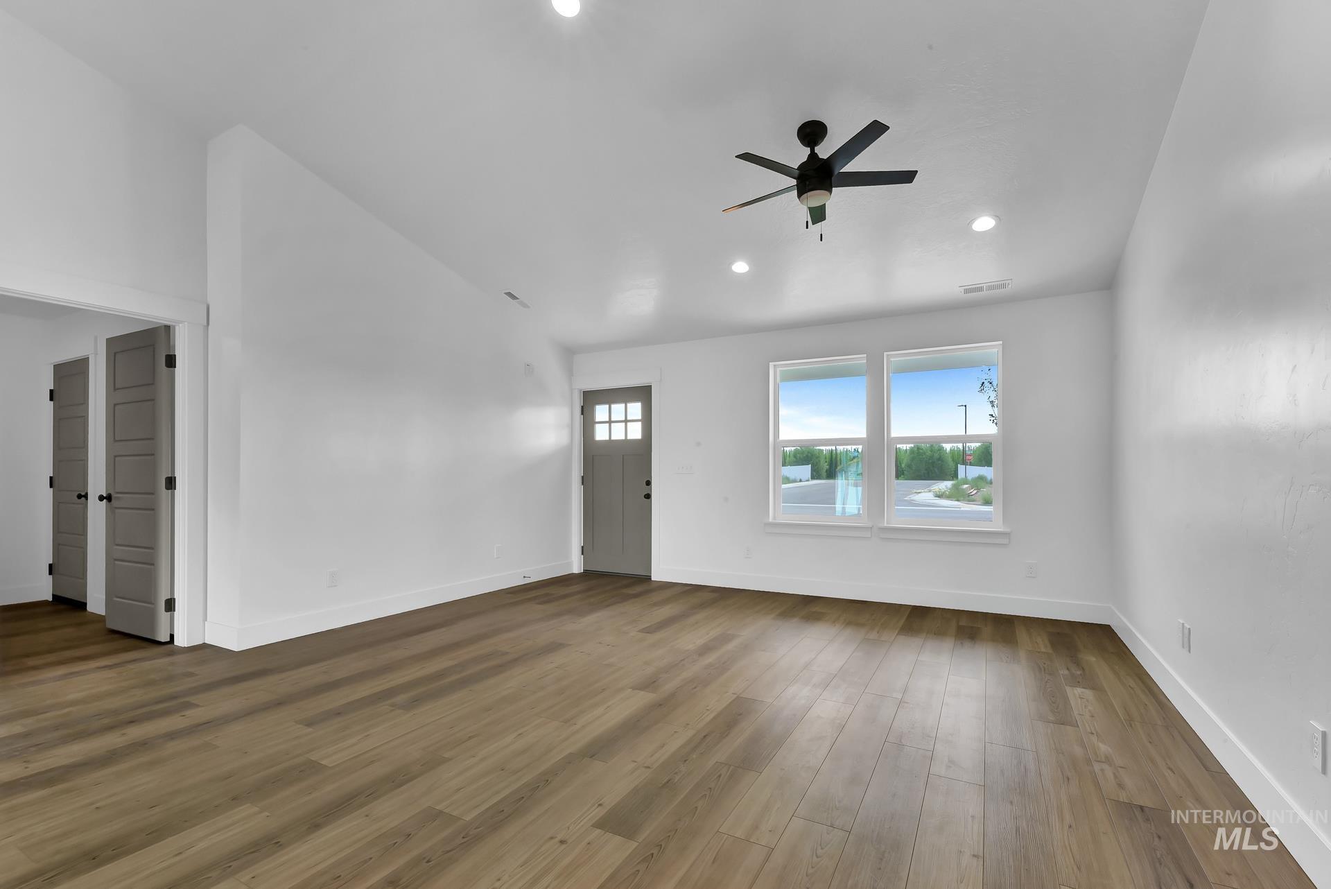 1160 Velvet Loop Wilder, ID 83676 - Photo 4 of 29 Unfurnished living room featuring hardwood / wood-style floors, a ceiling fan, and recessed lighting
