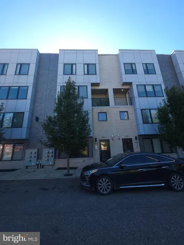 a car parked in front of a brick house