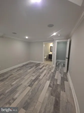 a view of a big room with wooden floor and a bathroom