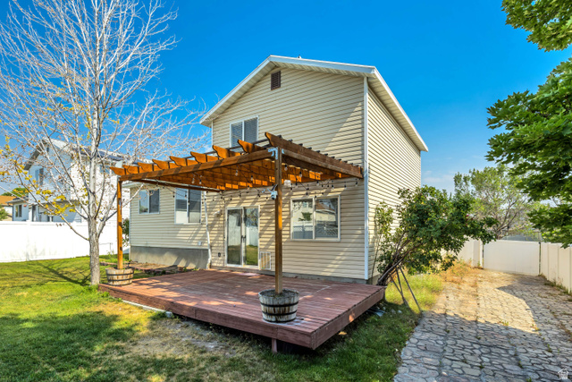 5529 Ridge Hollow Way Kearns, UT 84118 - Photo 22 of 23 Expansive wood-finish deck with an overhead pergola structure