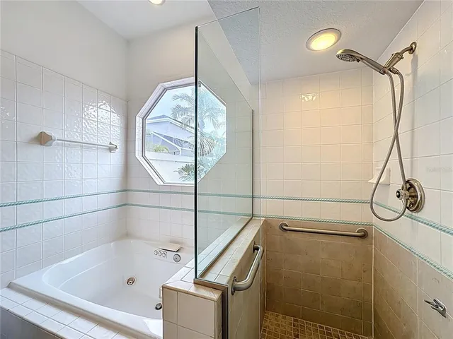 an empty room with windows and chandelier fan