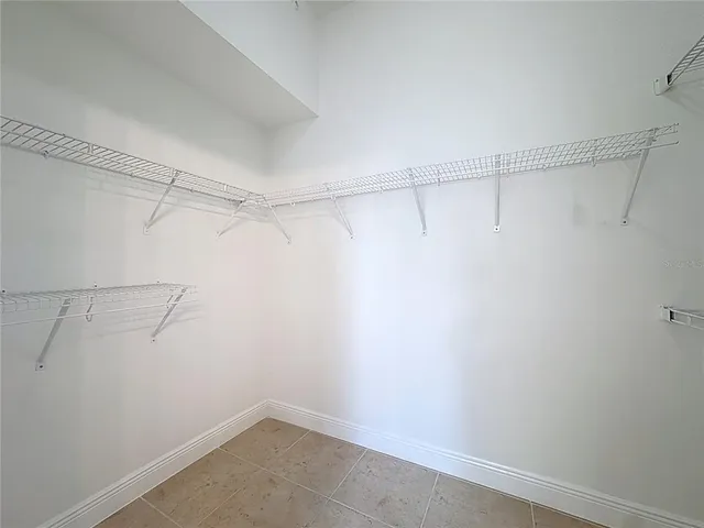 an empty room with a ceiling fan and window