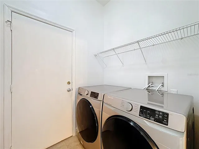 a view of a wooden house with a sink and potted plants