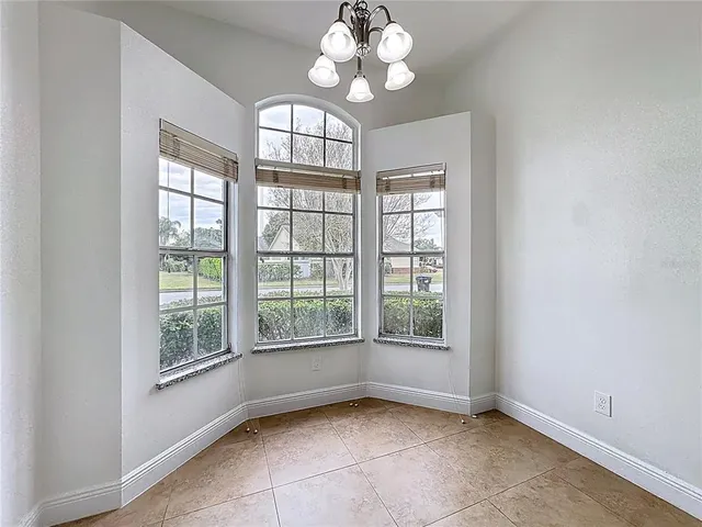 a kitchen with granite countertop white cabinets and stainless steel appliances