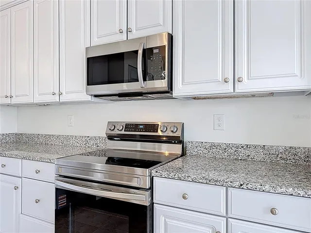a view of a livingroom with a ceiling fan and window