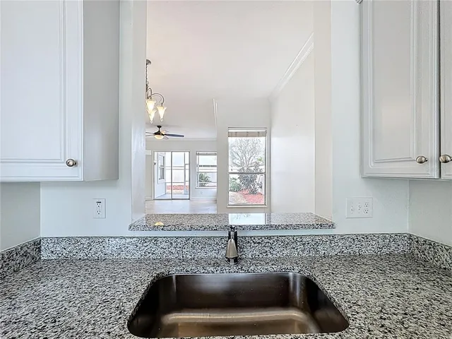 a view of an empty room with a ceiling fan