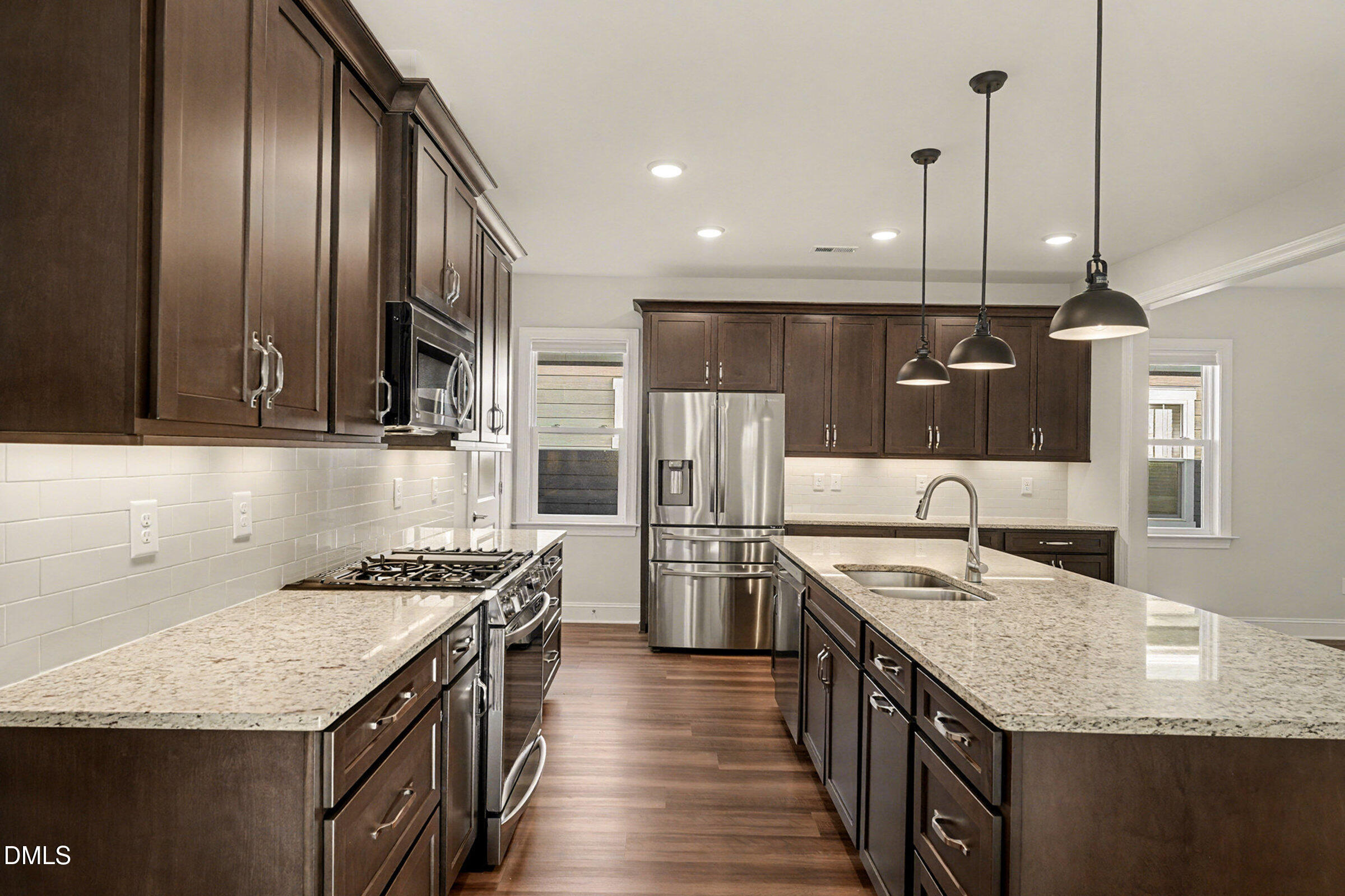 43 Davidson Street Clayton, NC 27520 - Photo 13 of 45 a kitchen with stainless steel appliances granite countertop a kitchen island a stove a refrigerator and a sink
