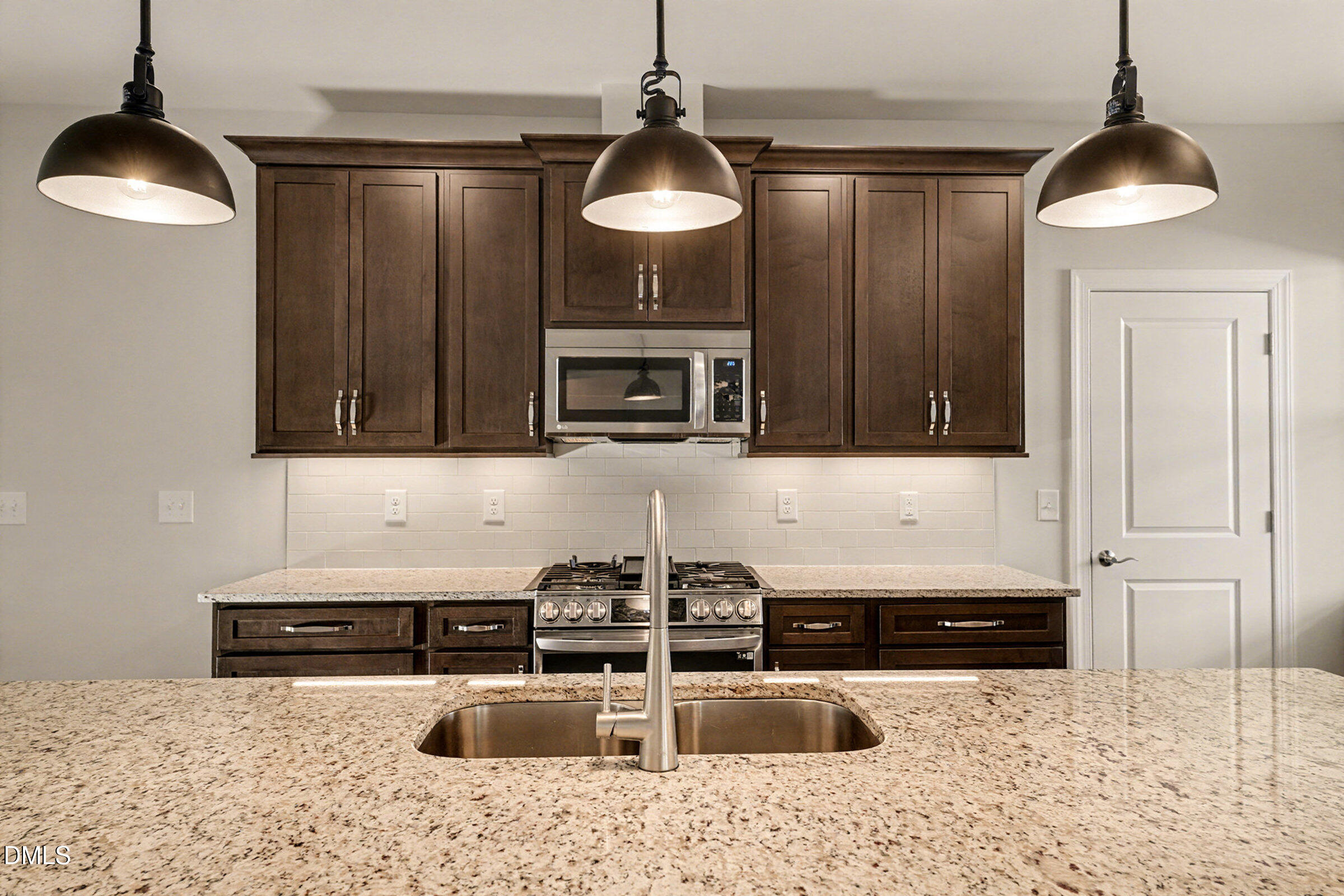 43 Davidson Street Clayton, NC 27520 - Photo 15 of 45 a kitchen with stainless steel appliances granite countertop a sink and a stove