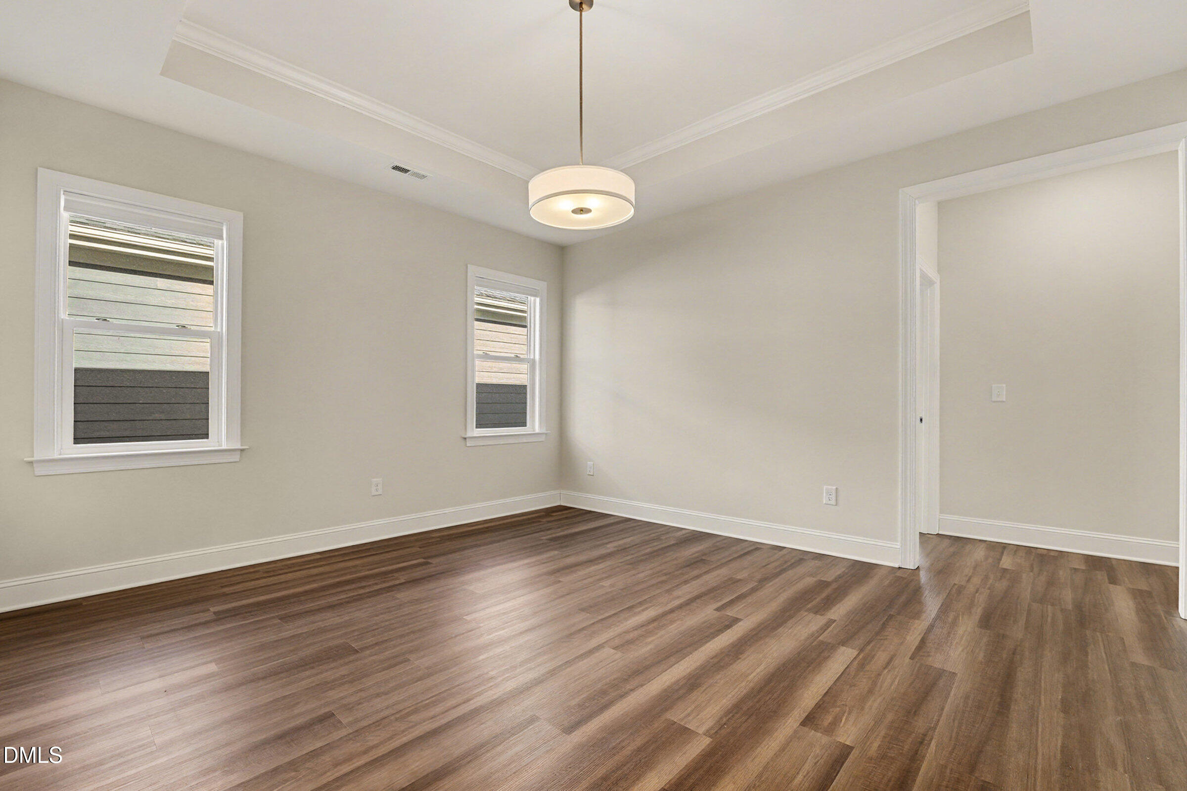 43 Davidson Street Clayton, NC 27520 - Photo 21 of 45 a view of an empty room with wooden floor and a window