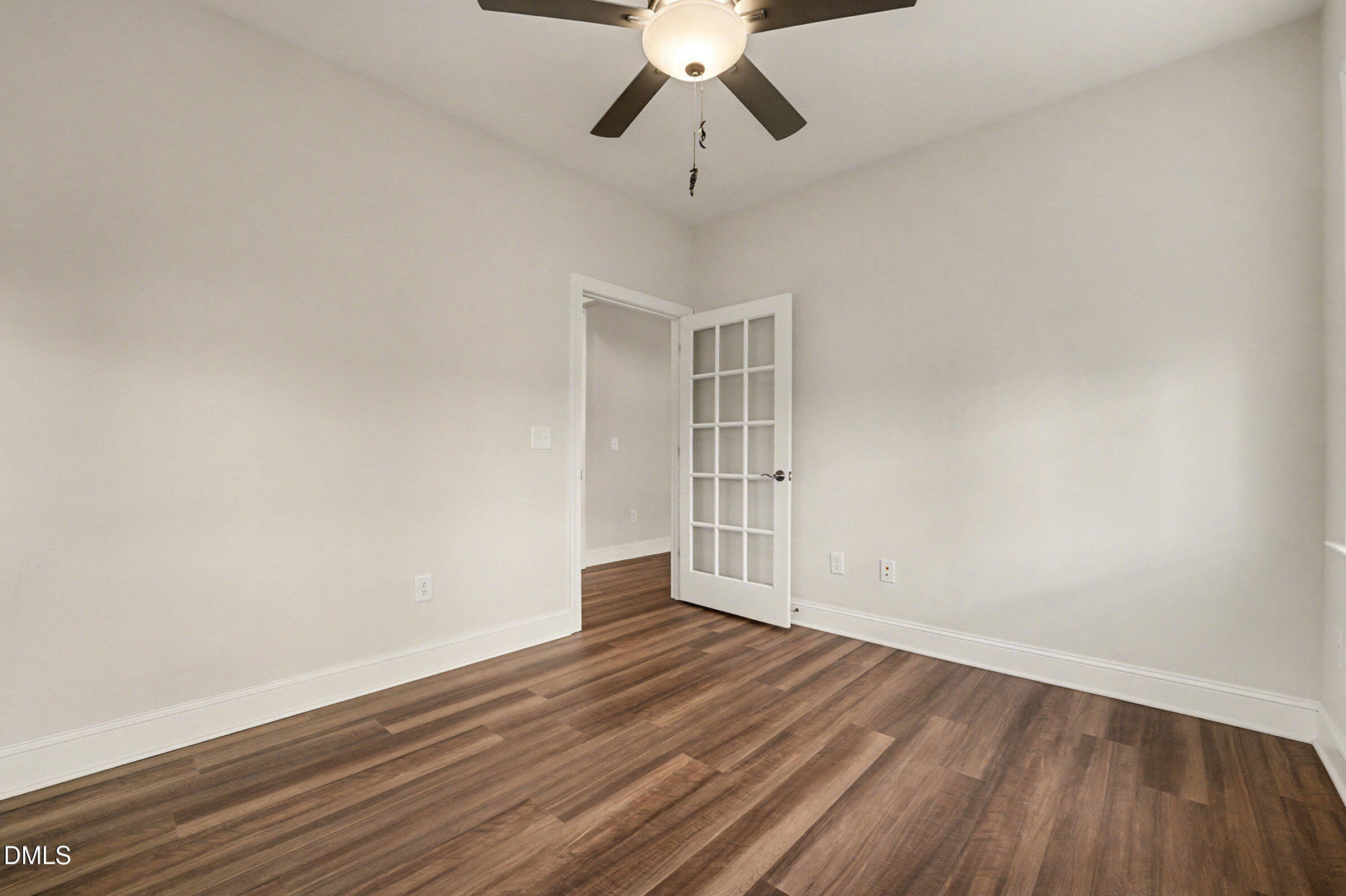 43 Davidson Street Clayton, NC 27520 - Photo 23 of 45 a view of empty room with wooden floor and ceiling fan