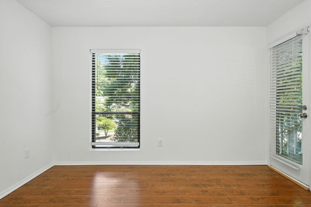 217 Tuxworth Circle Decatur, GA 30033 - Photo 12 of 38 a view of an empty room with wooden floor and a window