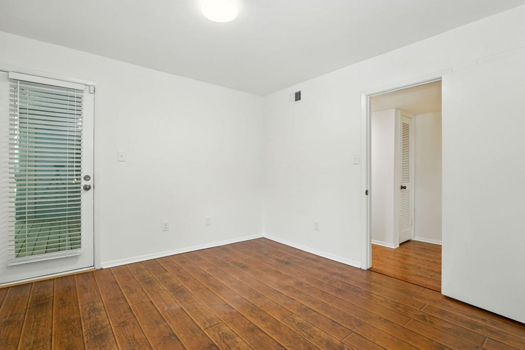 217 Tuxworth Circle Decatur, GA 30033 - Photo 14 of 38 a view of an empty room with wooden floor and a window
