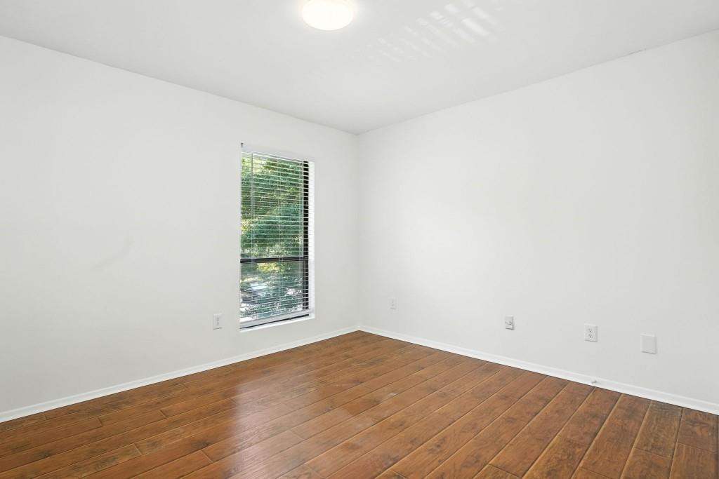 217 Tuxworth Circle Decatur, GA 30033 - Photo 18 of 38 an empty room with wooden floor and windows
