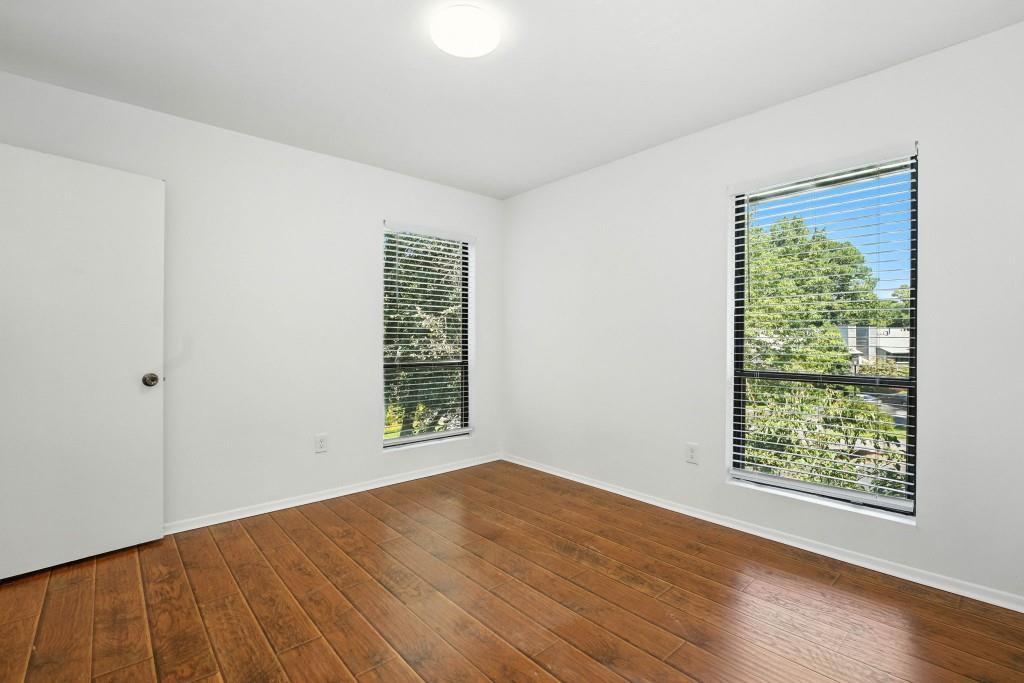 217 Tuxworth Circle Decatur, GA 30033 - Photo 19 of 38 a view of an empty room with wooden floor and a window