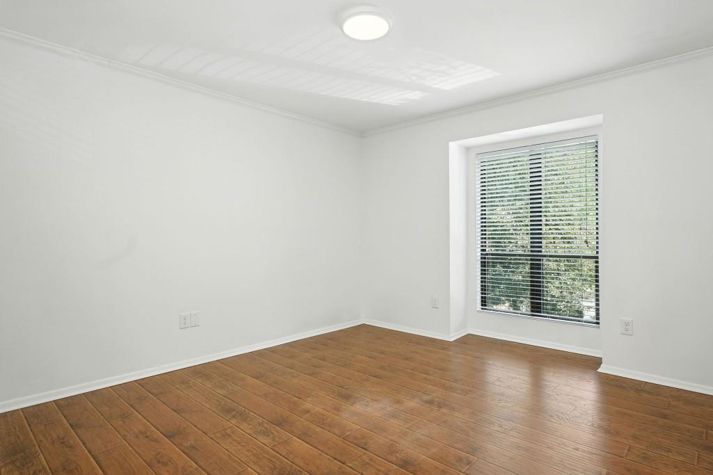 217 Tuxworth Circle Decatur, GA 30033 - Photo 21 of 38 an empty room with wooden floor and windows