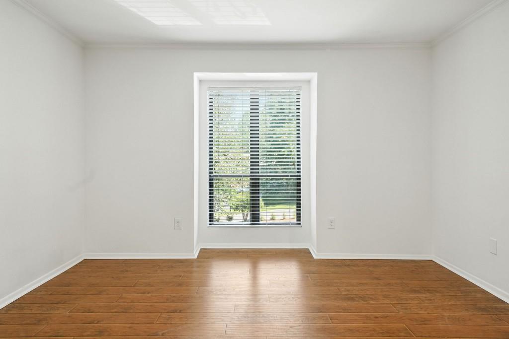 217 Tuxworth Circle Decatur, GA 30033 - Photo 22 of 38 a view of an empty room with wooden floor and a window