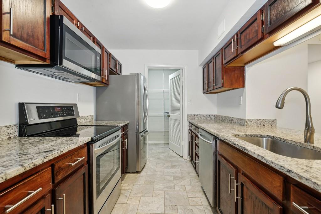 217 Tuxworth Circle Decatur, GA 30033 - Photo 5 of 38 a kitchen with stainless steel appliances granite countertop a sink stove and refrigerator