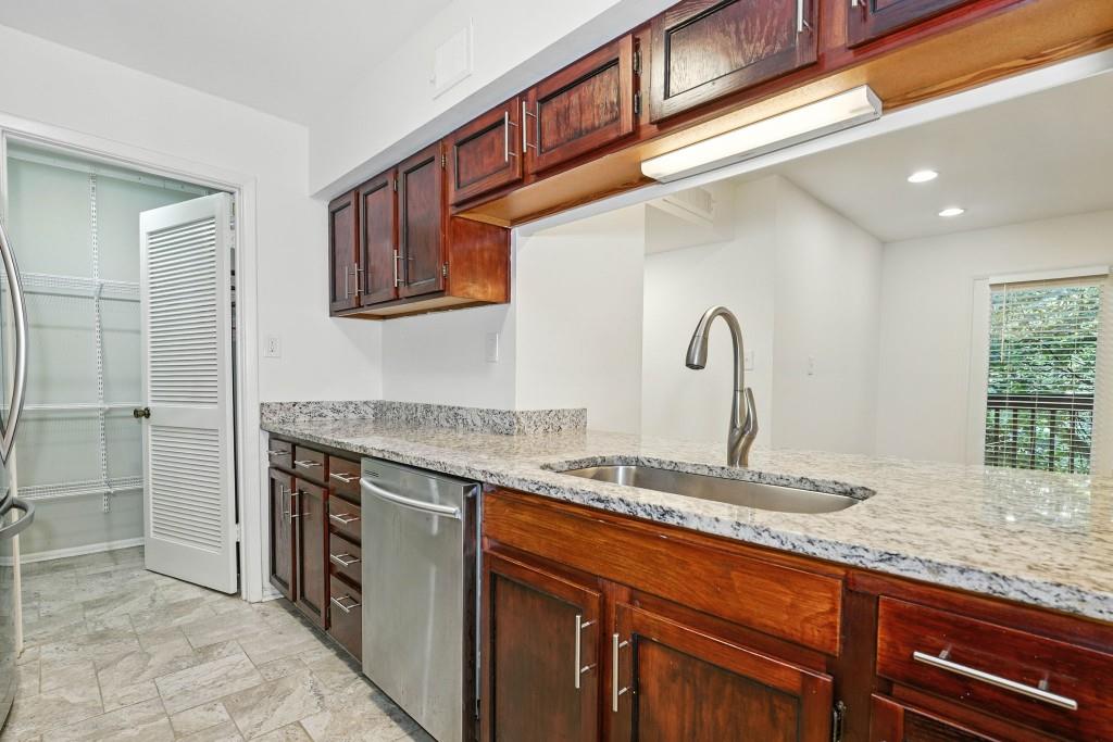 217 Tuxworth Circle Decatur, GA 30033 - Photo 7 of 38 a kitchen with stainless steel appliances granite countertop a sink stove and cabinets