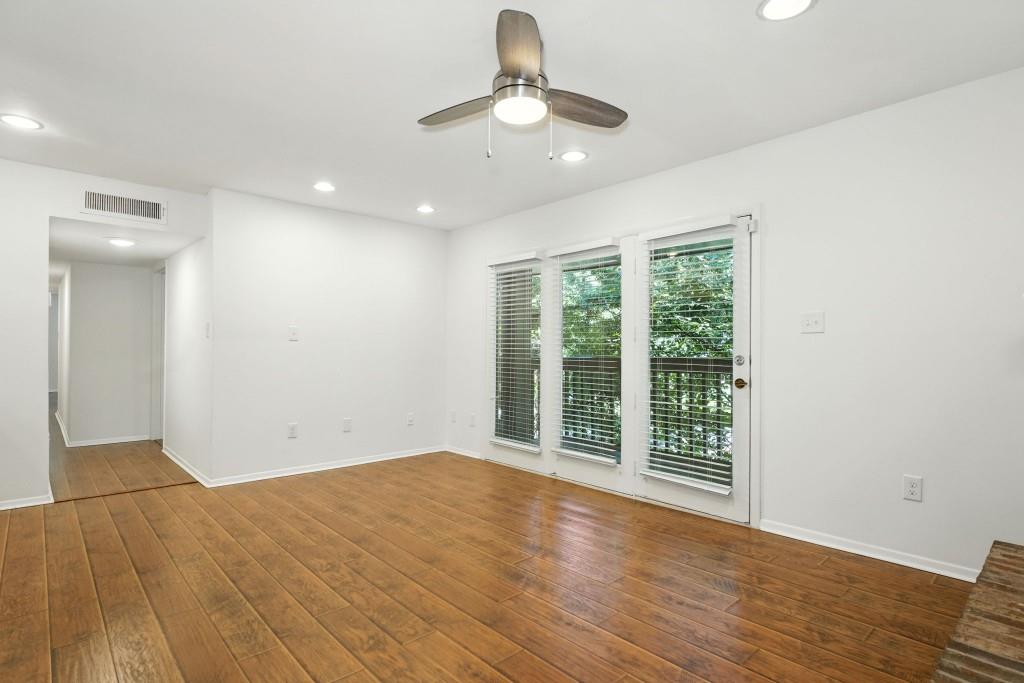 217 Tuxworth Circle Decatur, GA 30033 - Photo 8 of 38 a view of an empty room with wooden floor and a window