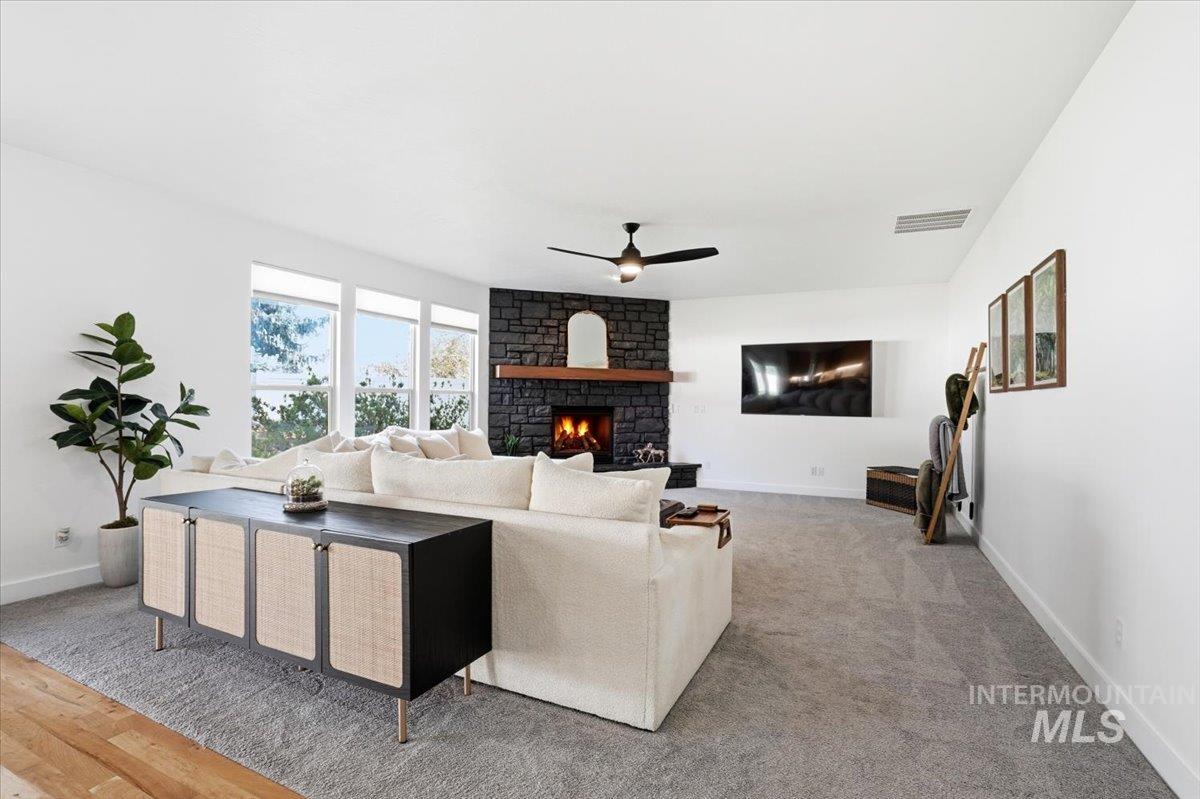 342 North Clearpoint Way Eagle, ID 83616 - Photo 16 of 50 Living area with a fireplace and ceiling fan