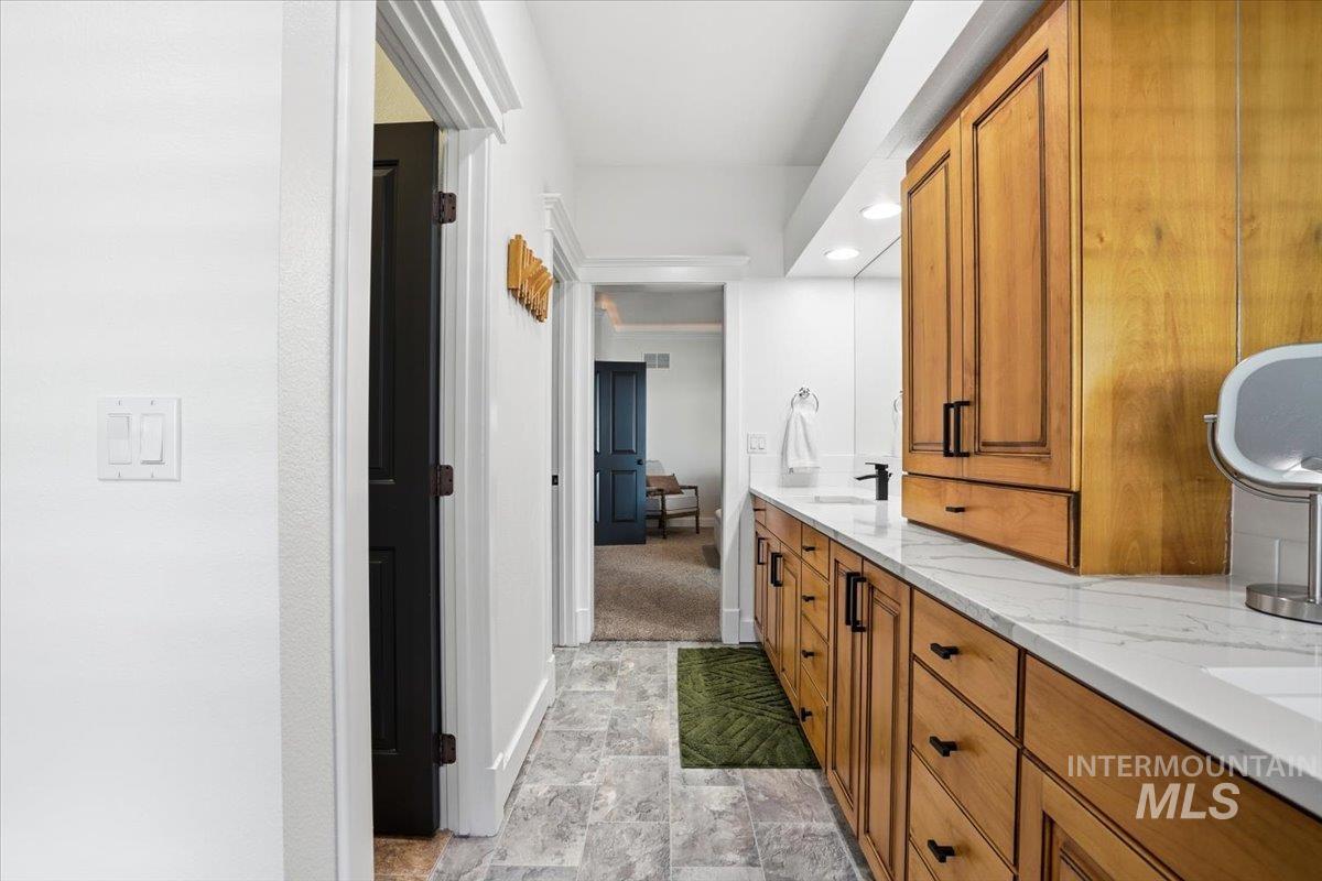 342 North Clearpoint Way Eagle, ID 83616 - Photo 21 of 50 Bathroom featuring stone finish flooring, double vanity, and recessed lighting