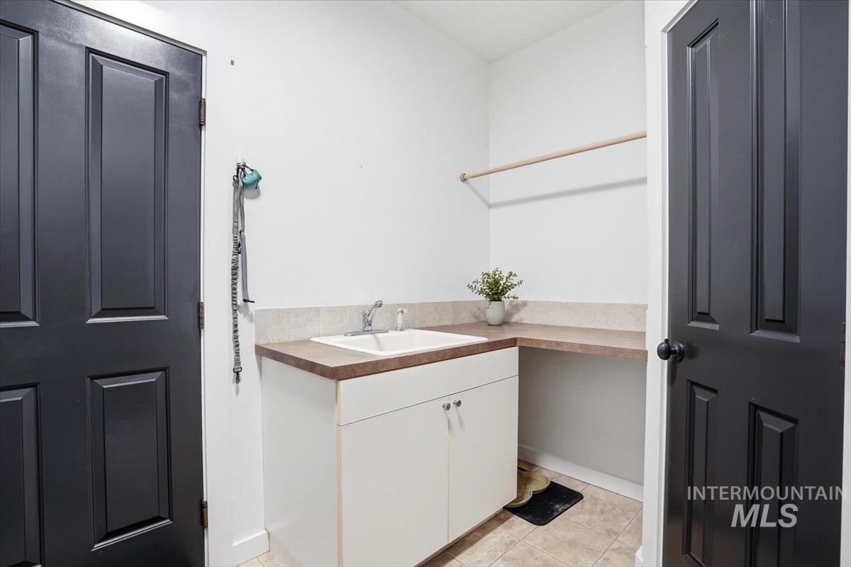 342 North Clearpoint Way Eagle, ID 83616 - Photo 23 of 50 Laundry room featuring a sink and light tile patterned floors
