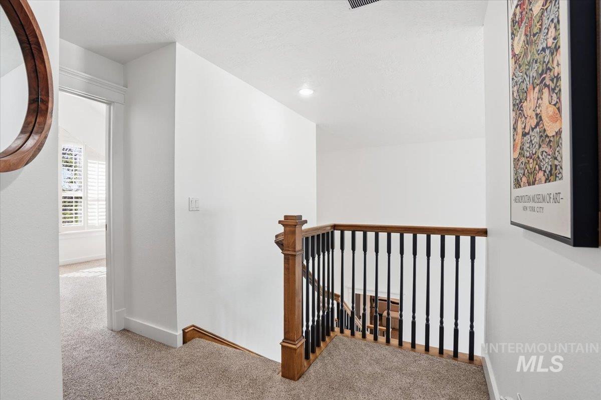 342 North Clearpoint Way Eagle, ID 83616 - Photo 26 of 50 Hallway featuring carpet and an upstairs landing