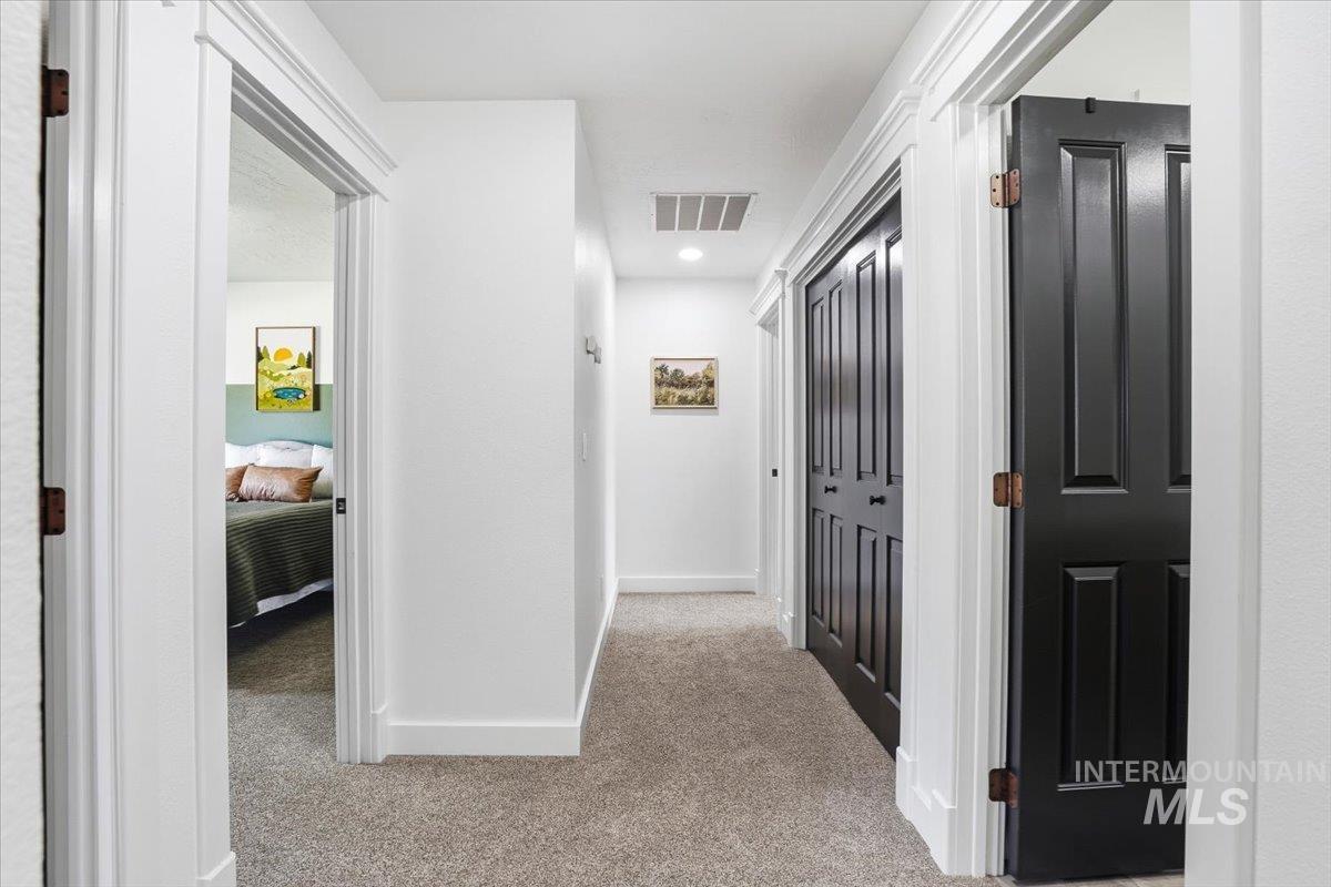 342 North Clearpoint Way Eagle, ID 83616 - Photo 27 of 50 Hallway featuring light colored carpet and baseboards