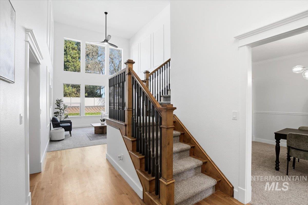 342 North Clearpoint Way Eagle, ID 83616 - Photo 4 of 50 Staircase featuring wood finished floors, a high ceiling, and a ceiling fan