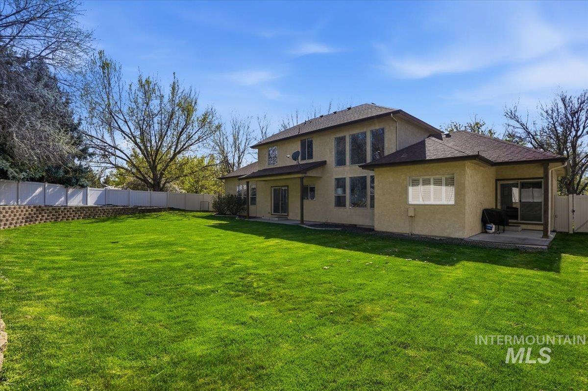 342 North Clearpoint Way Eagle, ID 83616 - Photo 45 of 50 Rear view of house with a fenced backyard, a patio area, stucco siding, and a shingled roof