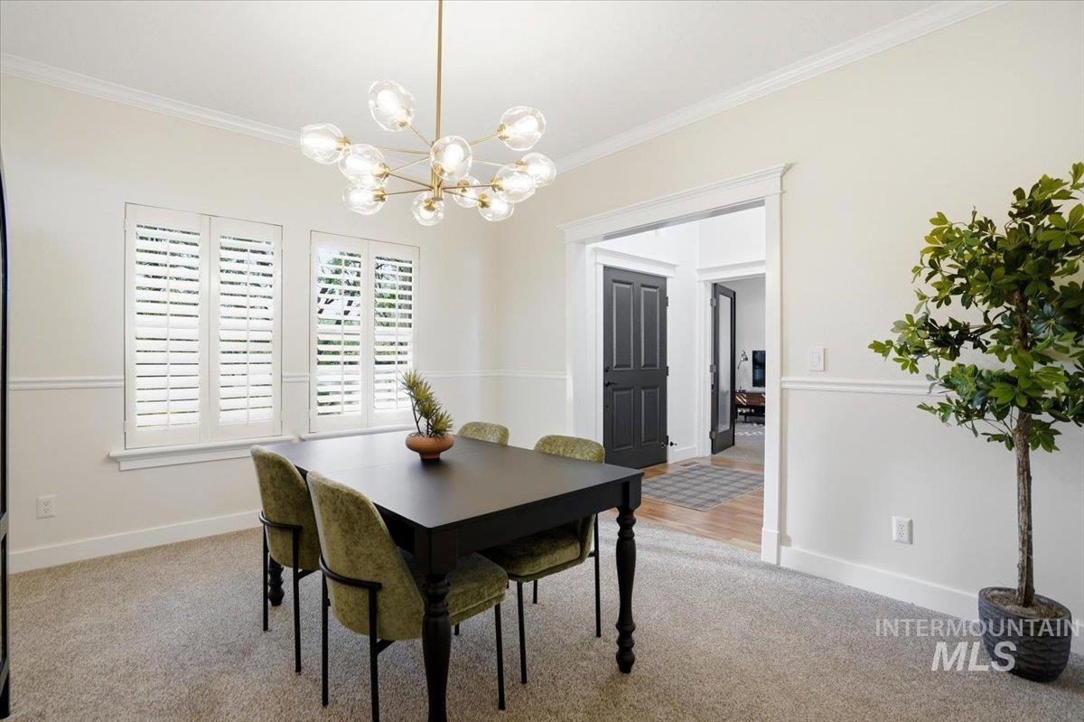 342 North Clearpoint Way Eagle, ID 83616 - Photo 6 of 50 Carpeted dining area featuring a chandelier and ornamental molding