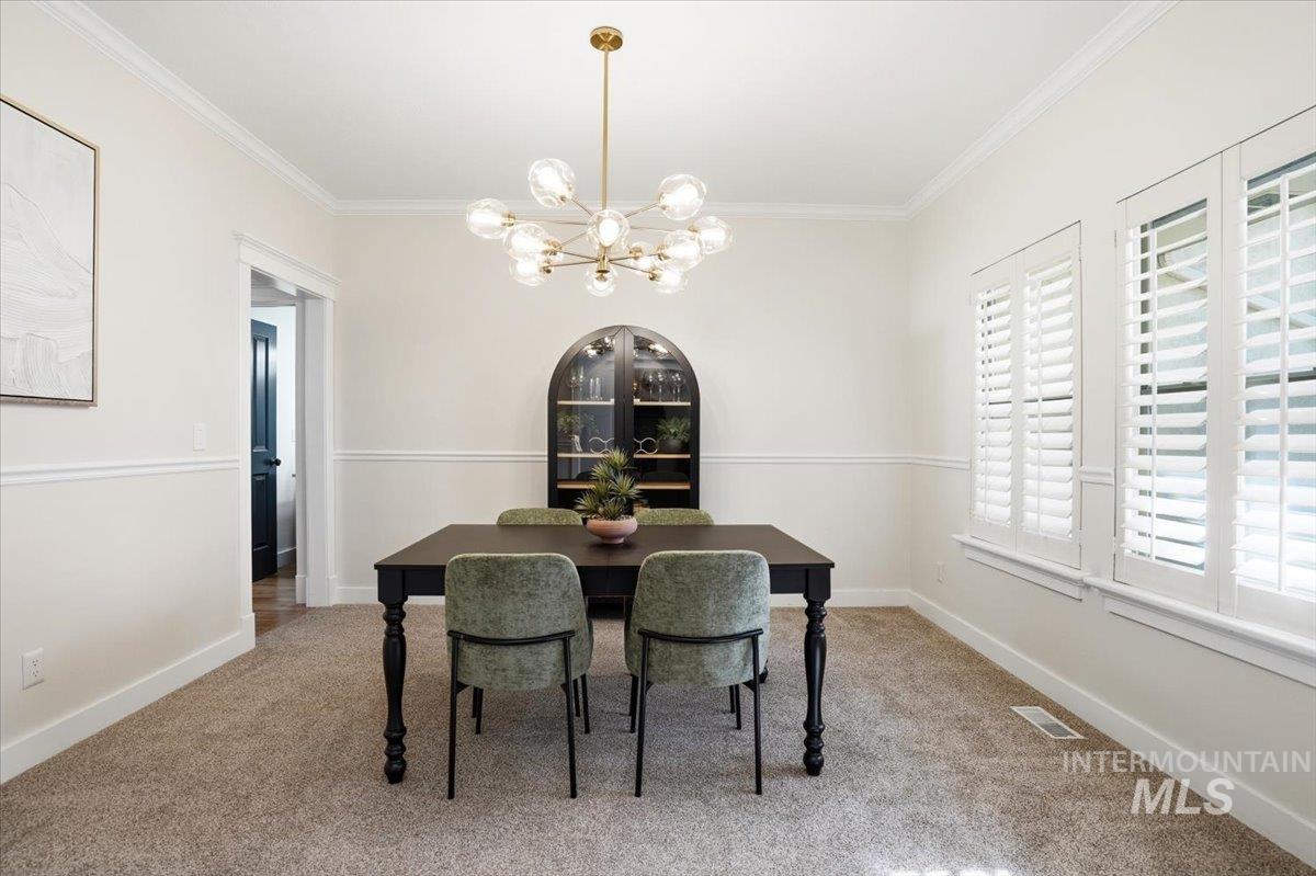 342 North Clearpoint Way Eagle, ID 83616 - Photo 7 of 50 Dining space with a chandelier, light carpet, and ornamental molding