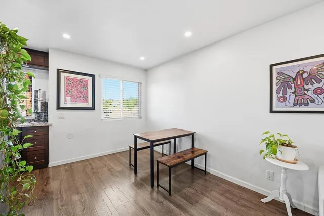 a view of a workspace with furniture and wooden floor