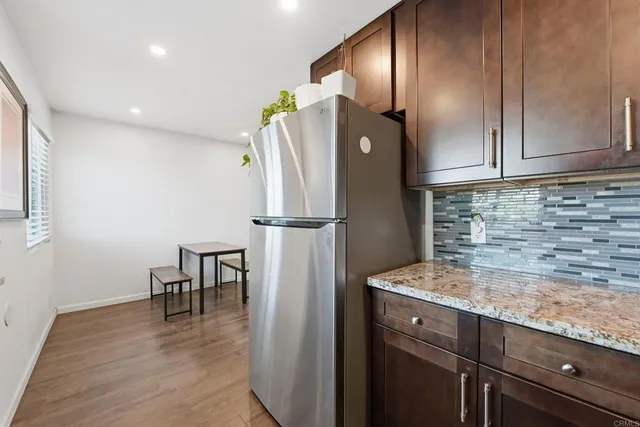 a kitchen with refrigerator and window