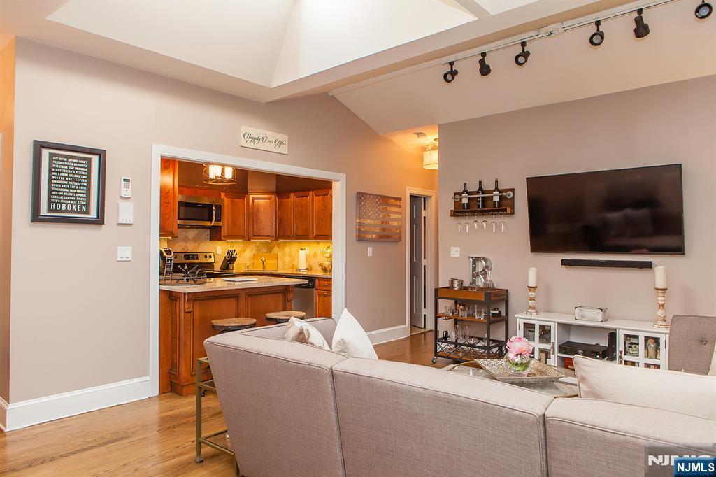 309 1st Street, Unit 3C Hoboken, NJ 07030 - Photo 3 of 13 a living room with furniture and a flat screen tv