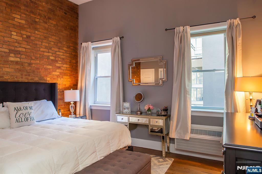 309 1st Street, Unit 3C Hoboken, NJ 07030 - Photo 8 of 13 a bedroom with a bed and wooden floor