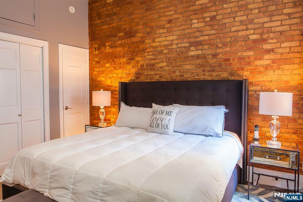 309 1st Street, Unit 3C Hoboken, NJ 07030 - Photo 9 of 13 a bedroom with a bed and a night stand