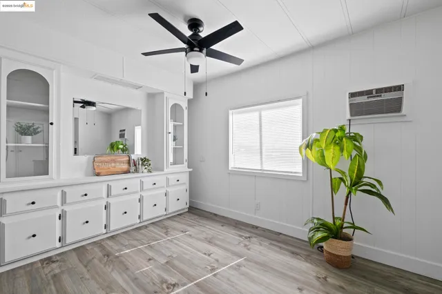 a view of living room with wooden floor furniture and a chandelier
