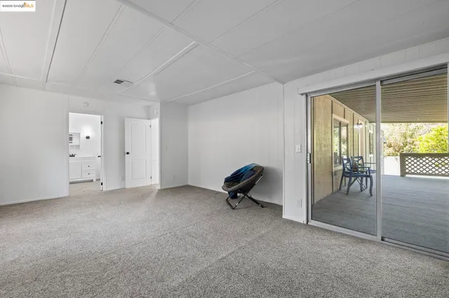 a room with white cabinets and wooden floor