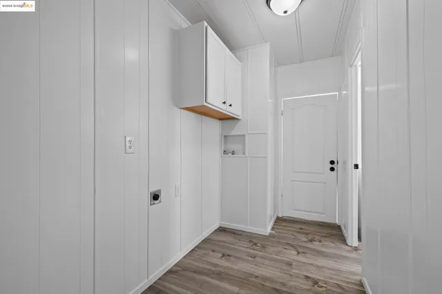 an empty room with wooden floor and window